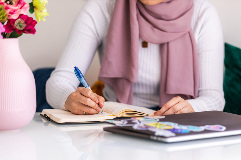 Woman journaling at a table